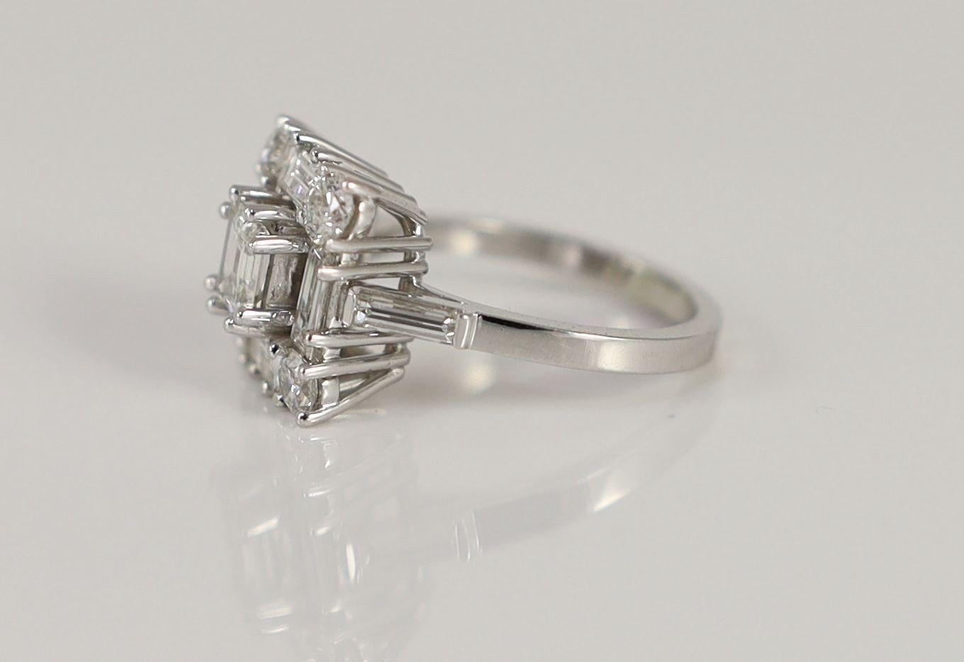 A square, baguette and round cut diamond set square cluster ring